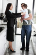 A working mother greeting her partner and baby son