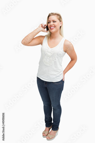 Foto: Smiling blonde woman holding her mobile phone Smiling blonde woman holding her mobile phone