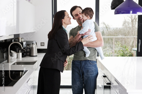 Photo: A working mother greeting her partner and baby son A working mother greeting her partner and baby son