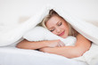 Blonde resting while embracing her pillow