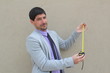 A businessman with a measuring tape