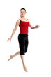 Girl in sportswear jumping jumping over white