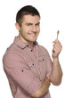 Young man holding house key isolated over white