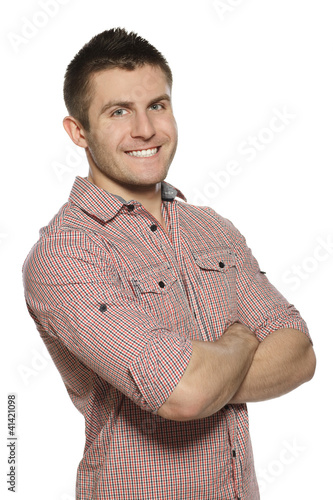 Photo: Handsome young man standing with hands folded Handsome young man standing with hands folded