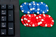 Fragment of black keyboard with gamble chips. Fragment of black keyboard with gamble chips.
