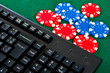 Fragment of black keyboard with gamble chips. Fragment of black keyboard with gamble chips.