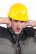 Tradesman covering his ears