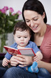 A mother and her baby son reading a book