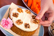 Decorating carrot cake with walnuts