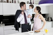 A couple and their baby son in the kitchen at breakfast time