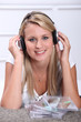 A blond woman, smiling at us, with CDs in front of her.