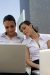 Businesswomen surfing the net outside