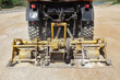 Road compactor tool compacting gravel