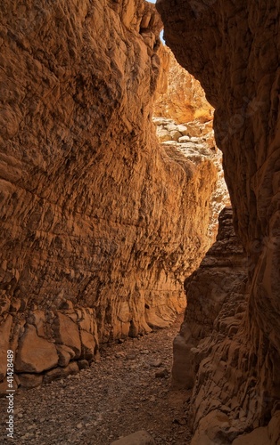 Photo: Narrow slot between two rocks in desert canyon Narrow slot between two rocks in desert canyon