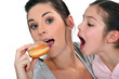 Woman and child fighting over a doughnut