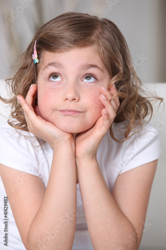 Photo: Cute girl looking upwards Cute girl looking upwards