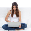 woman sitting on the sofa with modern laptop computer woman sitting on the sofa with modern laptop computer