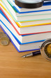 pile of booksand pen on wood pile of booksand pen on wood