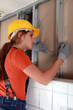 Female electrician working on wiring