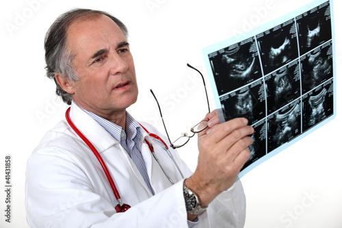 Photo: Doctor examining a scan Doctor examining a scan