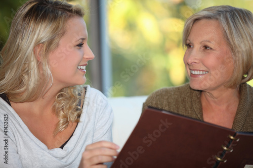 Photo: young woman and older woman at restaurant young woman and older woman at restaurant