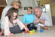 Elderly couple playing with their grandchildren