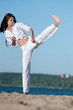 Athletic woman performing a kick Athletic woman performing a kick