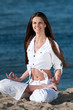 Woman practicing yoga on the beach Woman practicing yoga on the beach