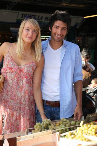 Photo: Couple shopping at market Couple shopping at market