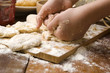 Detail of hands kneading dough