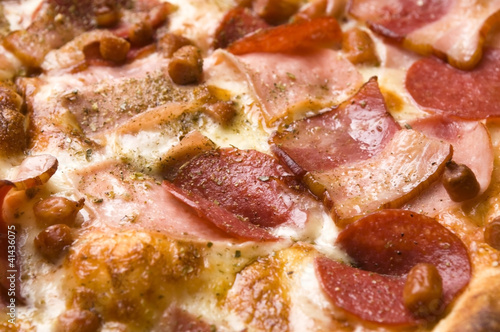 Photo: Italian pizza with bacon, salami and mozzarella cheese Italian pizza with bacon, salami and mozzarella cheese