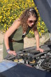 Curly blonde woman having troubles with her car