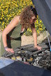 Curly blonde woman having troubles with her car