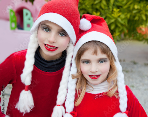 Photo: Christmas santa costumer kid girls portrait smiling Christmas santa costumer kid girls portrait smiling
