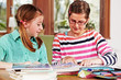 Foto: two teenage girls doing homework two teenage girls doing homework