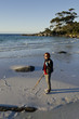 Woman at Binalong Bay drawing heart in sand, Tasmania Woman at Binalong Bay drawing heart in sand, Tasmania
