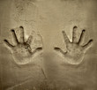 both hands print on cement mortar wall