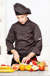 chef in black uniform cutting fruit chef in black uniform cutting fruit
