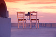 Santorini restaurant with chairs against sunset, Greece Santorini restaurant with chairs against sunset, Greece