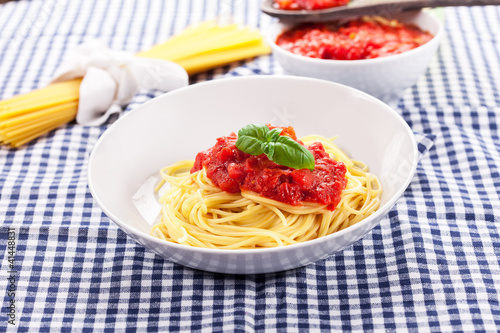 Photo: Spaghetti with Tomato Sauce on classical home table Spaghetti with Tomato Sauce on classical home table