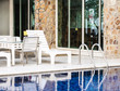White plastic bed arranged beside the pool at the restaurant.