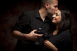 Happy Mixed Race Couple Flirting and Holding Wine Glasses