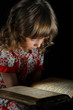 Teen girl reading the Book.