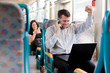 Happy businessman receiving good news on a train. selective focu