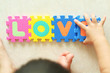 Toddler constructing the word Love