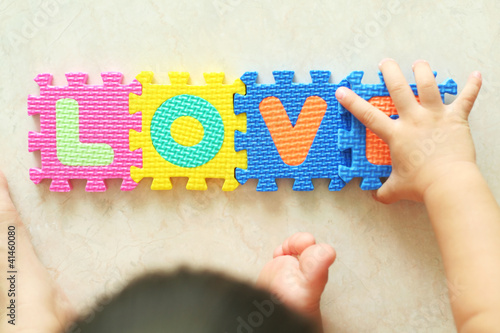 Photo: Toddler constructing the word Love Toddler constructing the word Love