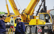 building workers and mobile cranes