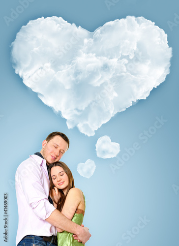 Photo: Portrait of young couple standing together and embracing. Blank Portrait of young couple standing together and embracing. Blank