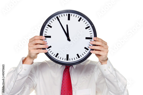 Photo: Manager im Stress mit Uhr vor Kopf. Manager im Stress mit Uhr vor Kopf.