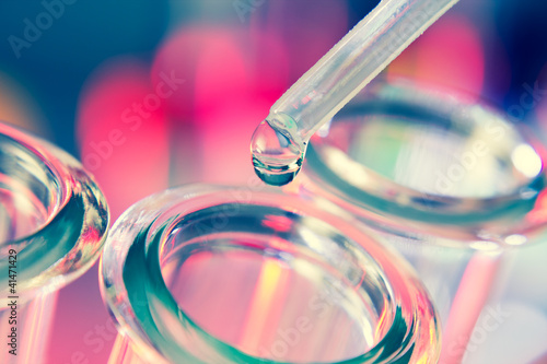 Photo: Test tubes closeup on blue background. Test tubes closeup on blue background.